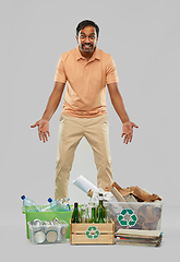 Image showing smiling man sorting paper, glass and plastic waste