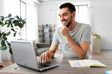 Image showing man with laptop working at home office