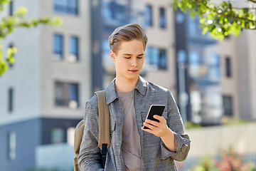 Image showing teenage student boy with phone and bag in city