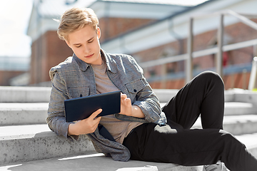 Image showing young manor teenage boy with tablet pc in city