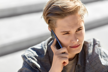 Image showing teenage boy calling on smartphone outdoors