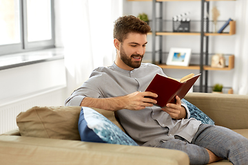 Image showing man reading book at home