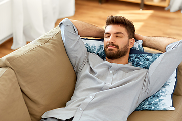 Image showing young man sleeping on sofa at home