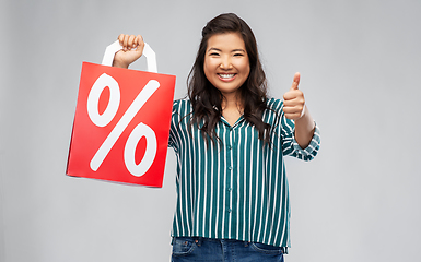 Image showing asian woman with percentage sign on shopping bags