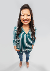 Image showing happy smiling asian woman over grey background