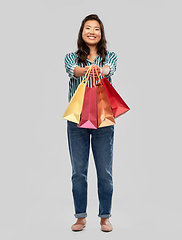 Image showing happy asian woman with shopping bags