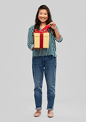 Image showing happy asian woman opening gift box