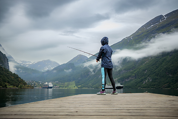 Image showing Woman fishing on Fishing rod spinning in Norway.