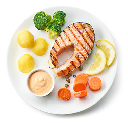 Image showing plate of grilled salmon steak and vegetables