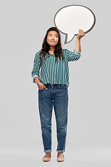 Image showing confused asian woman holding speech bubble