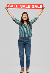 Image showing happy smiling young asian woman with sale banner