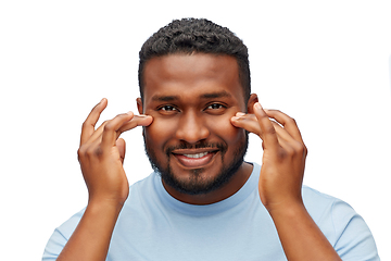 Image showing happy african american man touching his face