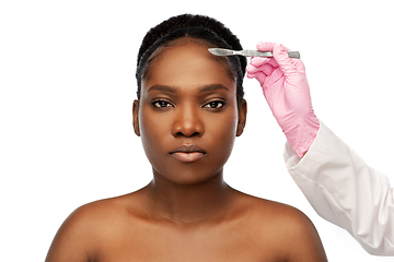 Image showing face of african american woman and scalpel knife