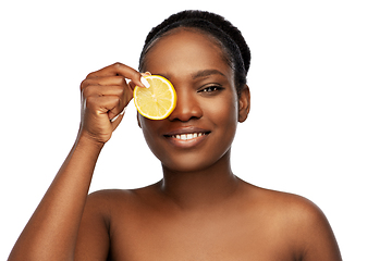 Image showing african american woman making eye mask of lemons