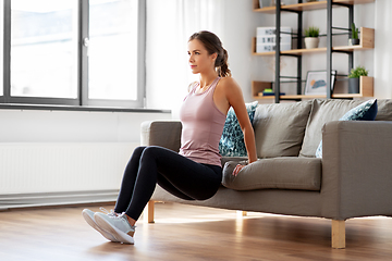 Image showing young woman exercising at home