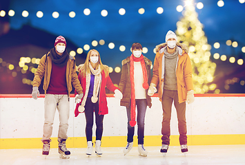 Image showing friends in masks on christmas skating rink