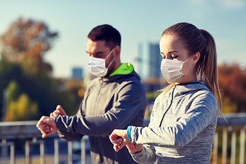 Image showing couple in masks running over city highway bridge