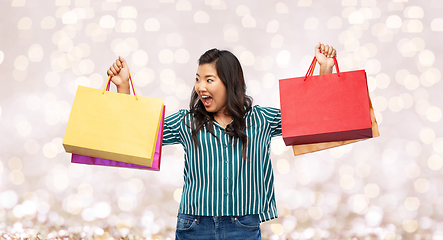 Image showing happy asian woman with shopping bags