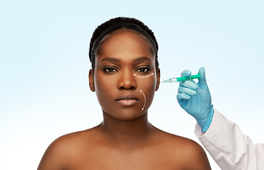 Image showing woman and plastic surgeon's hand with syringe