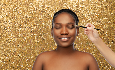 Image showing face of african woman and hand with make up brush