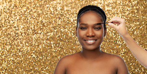 Image showing face of african woman and hand with mascara brush