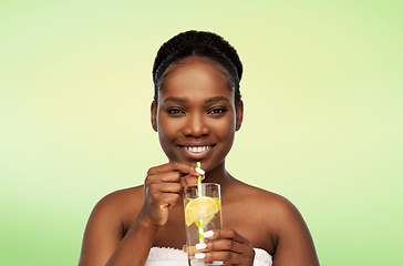 Image showing african american woman with glass of fruit water