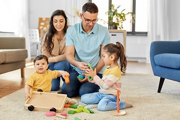 Image showing happy family palying with wooden toys at home