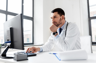 Image showing male doctor with computer working at hospital