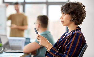 Image showing woman with smartphone at office conference