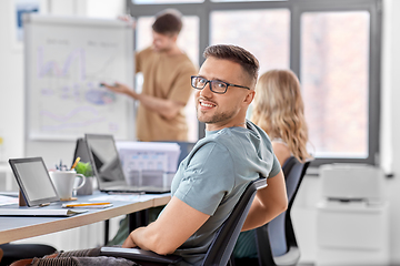 Image showing happy smiling man in glasses at office conference