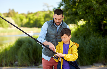 Image showing father and son fishing on river