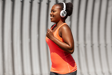 Image showing happy african american woman running outdoors