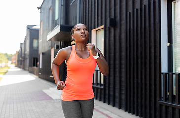 Image showing young african american woman running in city