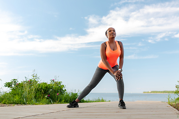 Image showing young african american woman exercising on beach