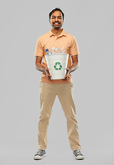 Image showing smiling young indian man sorting plastic waste