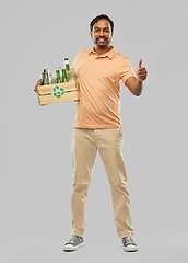 Image showing smiling young indian man sorting glass waste