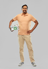 Image showing smiling young indian man sorting metallic waste