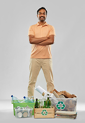 Image showing smiling man sorting paper, glass and plastic waste