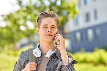 Image showing teenage student boy calling on smartphone in city