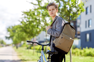 Image showing young man with bicycle and backpack on city street