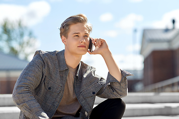 Image showing teenage boy calling on smartphone in city