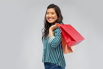 Image showing happy asian woman with shopping bags