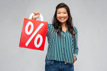 Image showing asian woman with percentage sign on shopping bags