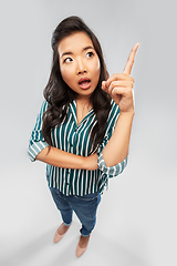 Image showing asian woman pointing finger up