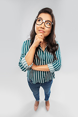 Image showing asian woman in glasses looking up and thinking