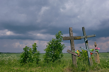 Image showing Next to road crosses and cloudy blue sky