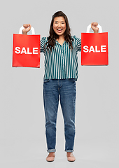 Image showing happy asian woman with shopping bags