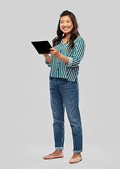 Image showing happy asian woman using tablet computer