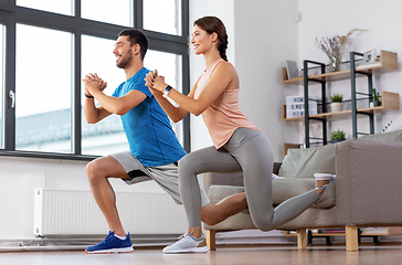 Image showing couple exercising and doing lunge at home