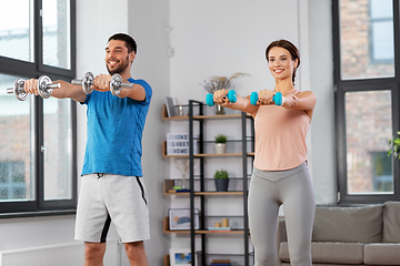 Image showing happy couple exercising at home